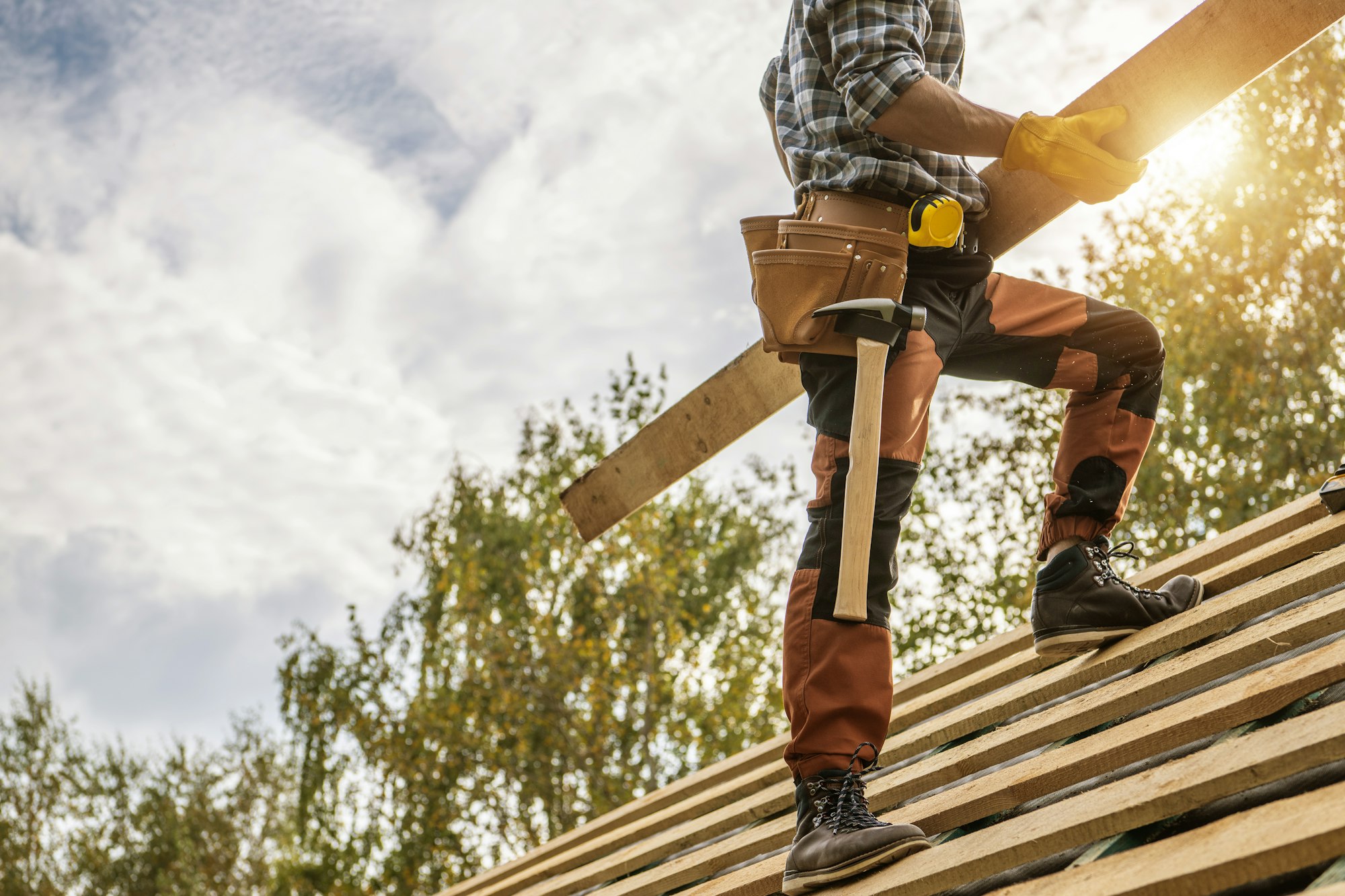 Building Construction Site Roof Worker with a Plank in His Hands