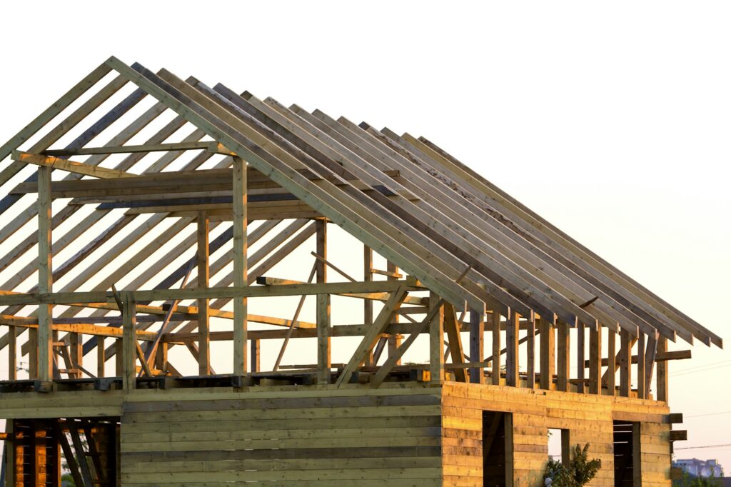 Close-up detail of new attic wooden roof frame against clear sky. Professional building, roofing